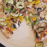 Pizza with vegan cheese at La Rucola in Tenerife