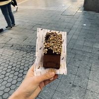 Vegan chocolate popsicle covered in dark chocolate coating and peanuts  at Loco Polo in Sevilla