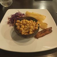 Garbanzos al ajillo con yuca frita (garlic chickpeas with fried yucca on the side. It comes with red cabbage salad and a slice of sweet plantain at El Trapiche in Panama City