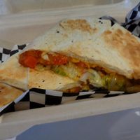 Black bean Crunchwrap special. Flour tortilla, refried beans, black beans, salsa, crispy tostada, shredded lettuce, shredded cheddar, diced tomatoes. Vegan. at Birch Cafe in Highland Heights