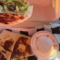 Corned beef hash crunchwrap (vegan corned beef, vegan cheese, hash brown patty, grilled onions, tofu scramble, and a side of thousand island).  at Birch Cafe in Highland Heights