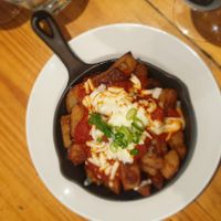 Patatas bravas with vegan cheese at Driftwood Cafe in Ocean Grove