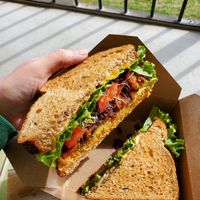 Buffalo chickpea sandwich with added avocado, coconut bacon, and cheeze at Life - The Vegan Drive Thru in Cape Coral
