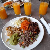 Mixed plate from the buffet with fresh orange juice at Paradise Food in Podgorica