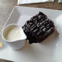 Hazelnut chocolate brownie, vegan cream & raspberry coulis at Tywarnhayle Inn in Perranporth
