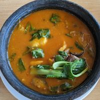 Fufu with palm nut soup, with tofu, mushrooms and pak choi at Tatale Vegan Restaurant in Accra