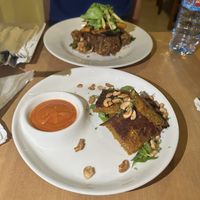 Tatale (front), Tatale Jollof rice (back)  at Tatale Vegan Restaurant in Accra