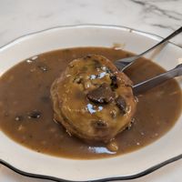 Knish with spinach and mushroom gravy at B and H Dairy Vegetarian Restaurant in New York City
