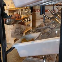 Filling paper bag with dried mangoes at Salud a Granel in Tijuana