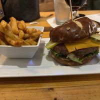Impossible burger with vegan muenster cheese added with a side of fries  at Hoptinger Beer Garden - Riverside in Jacksonville