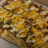 Stuffed crust pizza with marinara base, pepperoni, sausage, bacon, Just Egg, and a chipotle aioli drizzle. Incredible. at 4th & State in Columbus