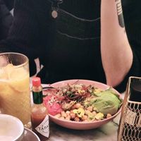 Buddha bowl of chickpea, beet hummus, quinoa, avocado and some salad. Also fresh juice lf orange, banana and mint. at Basilio in Lisbon