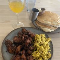 Mushroom scramble with crispy potatoes, short stack and mimosa . I added some cashew queso and all together is DELICIOUS!  at Bearcat Cafe - CBD in New Orleans