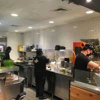 Inside tiny store, preparing the smoothies and juices. at Juice Generation - Broadway in New York City