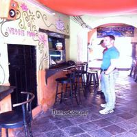 Old location, from 2010, View of the ordering window and seating area, as you enter the alley/restaurant. at Prasada in Cusco