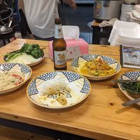 Papaya salad (cabbage and herbs behind), rice, yellow curry, fried morning glory at Markintiny in Bangkok