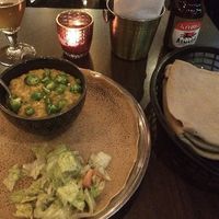 Injera dish and eritrean beer at Jebena in Stockholm