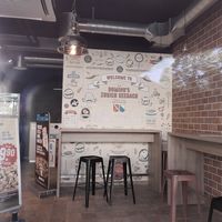 Interior with minimal seating at Domino's Pizza - Oerlikon in Zurich
