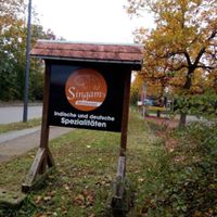 Sign next to the main road at Singam's in Forst