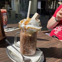 Vegan cosmopolitan milkshake—absolutely delicious and great hazelnut flavor!! Complete with caramel-drizzled whipped cream and a chocolate wafer cookie.  at Lenok's Burger - L15 in Mannheim