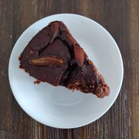 Slice of chocolate cake with fig slices at Bahji Bakery Rosales in Bogota