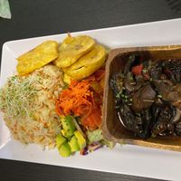 Sautéed mushrooms in wine with rice pilaf and salad.   at Antojitos Veganos in Bayamon
