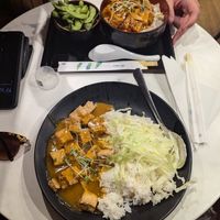 Tofu curry (nearest) and chilli tofu with edamame side at Pompoko in Brighton