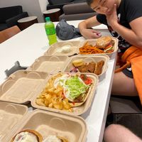 Cinnamon rolls, gyro, thai chili wings, and spicy crispy chicken sandwich at The Chicago Diner - Lakeview in Chicago