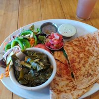 The special that day: crumbled veggie ground quesadilla with pico de gallo and avocado crema. Served with a side salad and collard greens. at Sluggo's North Vegetarian Cafe in Chattanooga