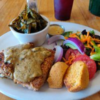 Pecan-crusted tofu atop mashed potatoes and gravy, served with side salad, collard greens and cornbread at Sluggo's North Vegetarian Cafe in Chattanooga