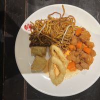Platter or noodles, sweet & sour chicken, onion rings, crispy potatoes and chilli sauce at Su Vegan Buffet in West London