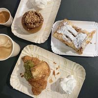 Partendo dall’alto e in senso orario: donuts alla nocciola accompagnato da panna montata, strudel di mele e cornetto al pistacchio salato accompagnato da panna montata  at Zia Esterina in Garbagnate Milanese
