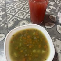Hearty vegetable and lentil soup and fresh strawberry juice as part of set lunch  at Comer Sanar Vivir in Cuenca