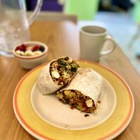 Curry wrap with a side of mixed fruit.   at Lucy's Cafe in Chicago