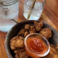 Cauliflower wings (vegan & super good) and coconut water with ice  at Moochie's Cafe in Weligama