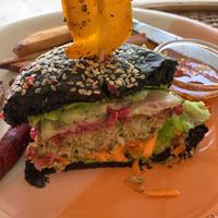 Vegan burger inside! Charcoal bun, it is not burnt!  at Moochie's Cafe in Weligama