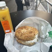 Spinach and artichoke tofu cream cheese in garlic bagel and fresh orange juice   at Liberty Bagels in New York City