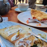 With the sauce: vegan curry crêpe, in the back: vegetarian crêpe with tomato and cheese at La Teteria  in Malaga