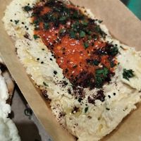 Hummus with muhammara and parsley. YUM!!! at Santo Falafel in Florence