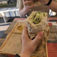 Pita with falafel and focaccia with potato in the background at Santo Falafel in Florence
