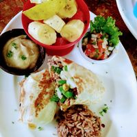 Vegan burrito, hummus, fruit cup at Simon Says  in San Juan Del Sur