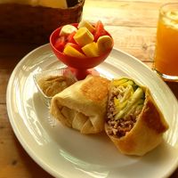 Vegan burrito with bell peppers, Pico de Gallo and corn, fresh fruit and Hummus. Glass of juice of the day. at Simon Says  in San Juan Del Sur