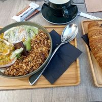 Soya yoghurt bowl with granola, kiwi and passionfruit + vegan croissant at Kaffee Kamiel in Bruges