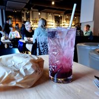 Homemade lemonade of red fruits with bag with bread at Kaffee Kamiel in Bruges