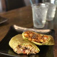 Side view of a vegan chicken and soyrizo potato burrito at The Good Bar in Long Beach