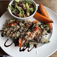 Stuffed zucchini - comes with the side salad. Our server said that the sweet potato wedge side is vegan without the honey sauce so I ordered those as well.   at Harvest 18 in Durham