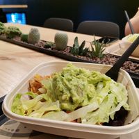 A bowl with rice, nachos, Salat and guacamole at Burritos in Barcelona