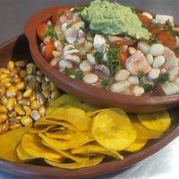 ECUADORIAN CEVICHE
Contains lupins beans, mushrooms, cherry tomatoes, avocado, sweet corn and served with green banana chips and toasted corn at Prana Veggie in Quito
