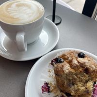 Latte and partially eaten blueberry muffin  at Lulu Green in Boston