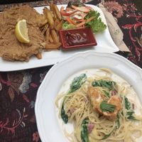deep fried schnitzel and chips, and creamy carbonara with smoked ‘ham’ and fried ‘shrimp’  at Vegan Loving Hut Neubau in Vienna